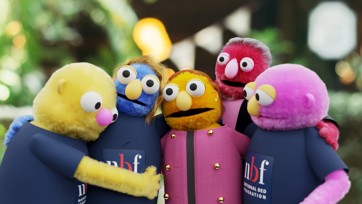 image of puppets depicting NBF members hugging